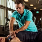 Physical therapist treating a patient's shoulder at a physical therapy clinic in Lakeland and Brandon, FL