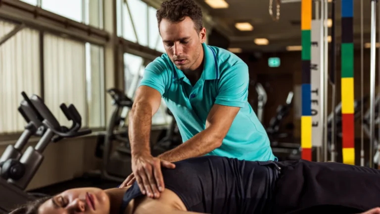 Physical therapist treating a patient's shoulder at a physical therapy clinic in Lakeland and Brandon, FL